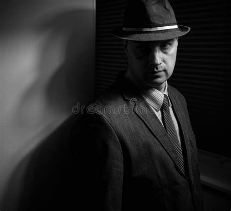 man   suit  fedora   dramatic noir style lighting stock image