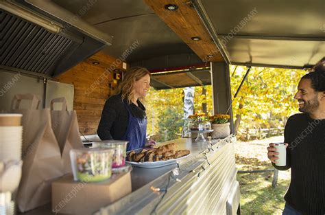 Happy Food Cart Owner Talking With Customer In Park Stock Image