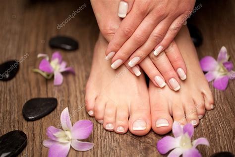 Relaxing Pink Manicure And Pedicure With A Orchid Flower Stock Photo By