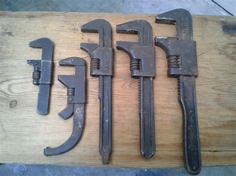 Five Wrenches Are Sitting On A Wooden Table