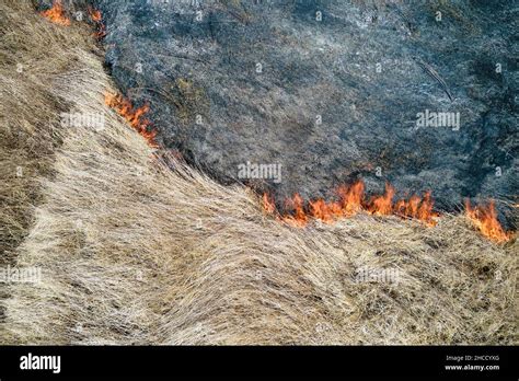 Aerial View Of Grassland Field Burning With Red Fire During Dry Season Natural Disaster And