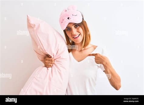 Beautiful Redhead Woman Wearing Sleeping Mask Cuddling Pink Pillow Over