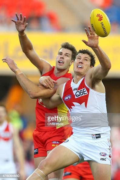 Keegan Brooksby of the Suns and Kurt Tippett of the Swans compete for ...