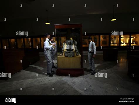 Visitors Look At Artifacts Displayed In Glass Cases At The Peshawar