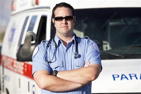 Portrait Of A Confident Male Paramedic Worker Standing In Front Of An