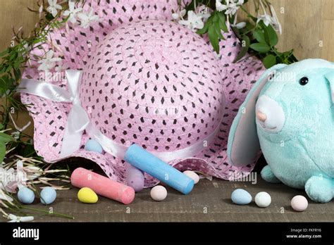 White Easter Bunny Sitting With Colored Eggs In A Nest Of Jasmines