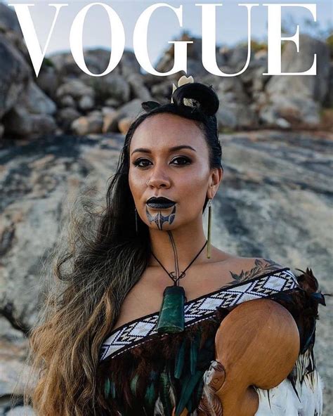 A Woman With Makeup And Feathers On Her Face Is Posing For The Cover Of