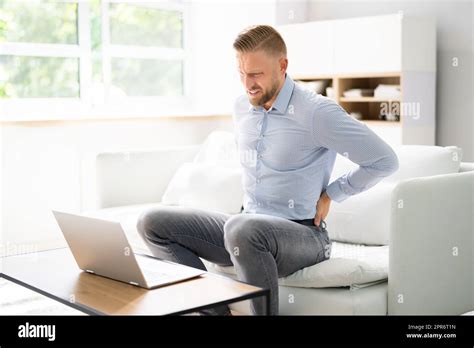 Back Pain Bad Posture Man Sitting Stock Photo - Alamy