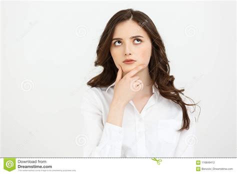 Thinking Caucasian Business Woman With Hand On Her Chin And Looking Up