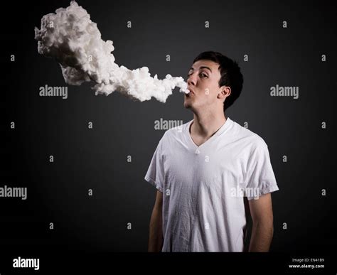 Man Blowing Smoke Stock Photo Alamy