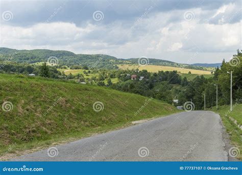 Summer Day Landscape With Road Cloudy Sky And Small Houses Ukraine