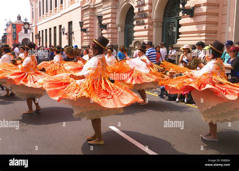 Women In Traditional Peruvian Dress Dancing In The Street In Lima Stock