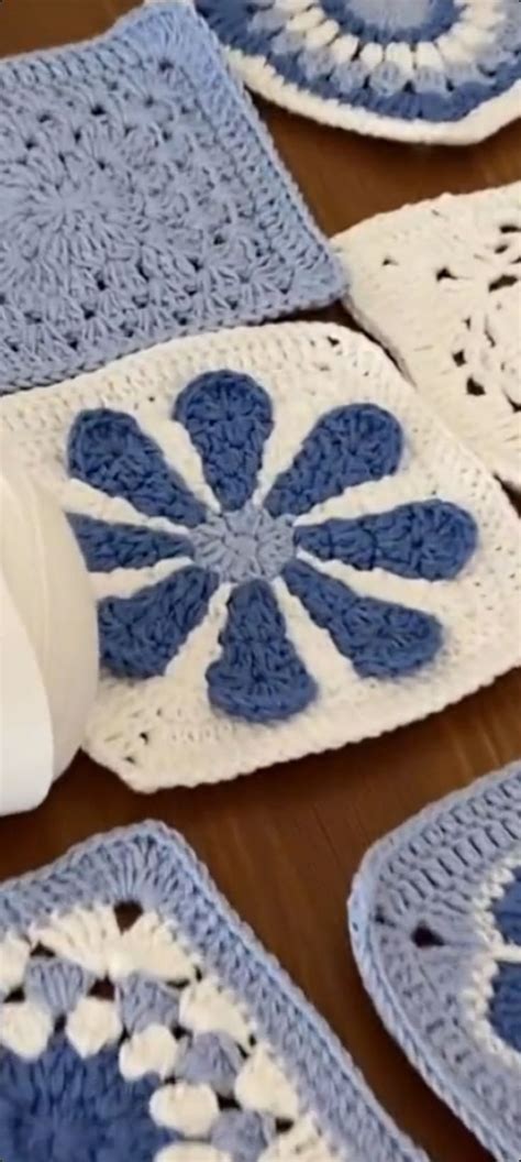 Blue And White Crocheted Coasters Are Laid Out On A Wooden Table Top