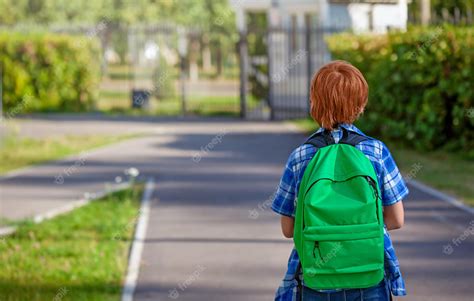 Premium Photo A Student With A Backpack Goes To Primary School A