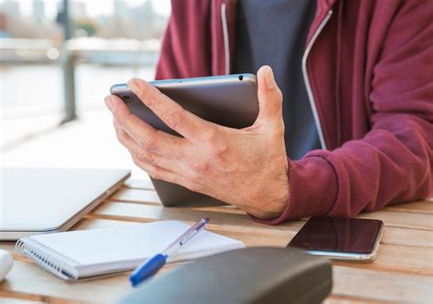 Free Photo Close Up Of Man S Hand Holding Digital Tablet In Hand At