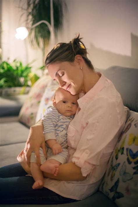 Young Beautiful Mother Breastfeeding Her Newborn Baby Boy Stock Photo