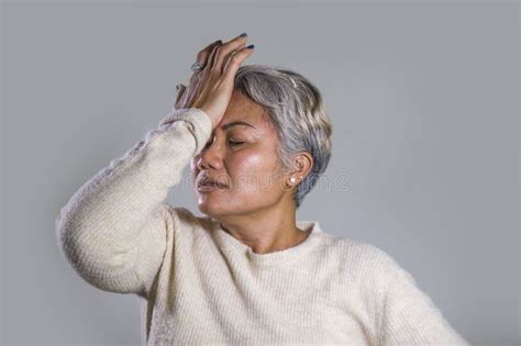 Dramatic Portrait Of Attractive Sad And Depressed Middle Aged Asian