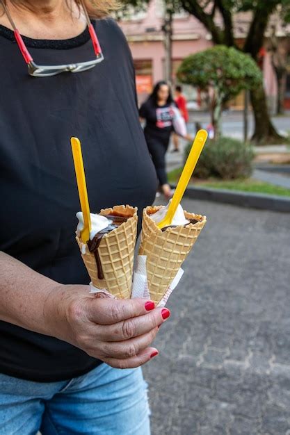 Premium Photo Midsection Of Woman Holding Ice Cream Cone