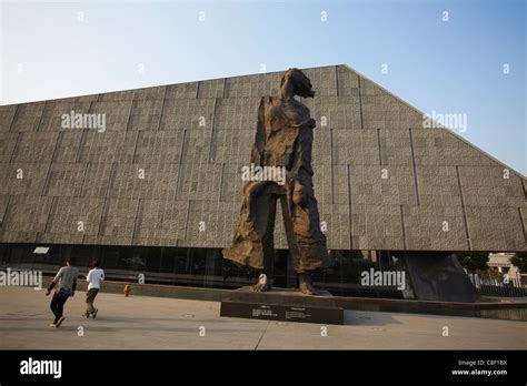 People Walking Past Statues At Memorial For The Nanjing Massacre