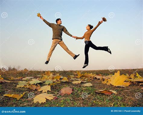 Jump Couple Autumn Leaves Stock Images - Image: 295144