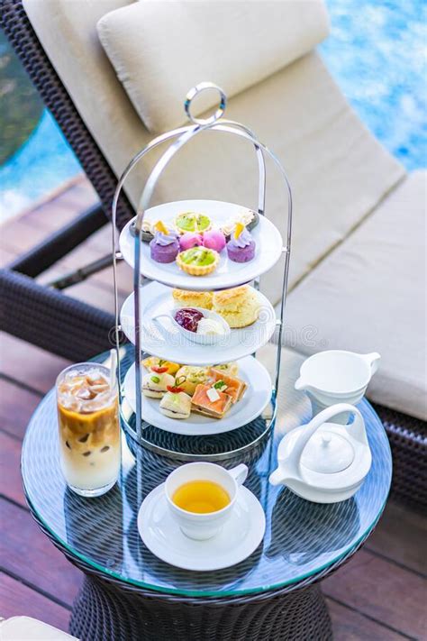 Afternoon Tea Set With Latte Coffee And Hot Tea On Table Neary Chair