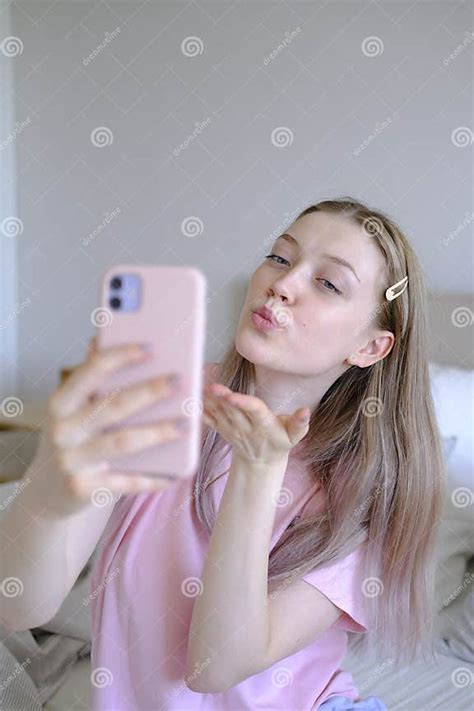 Cute Girl 15 18 Years Old Sitting On The Bed Makes A Selfie Stock