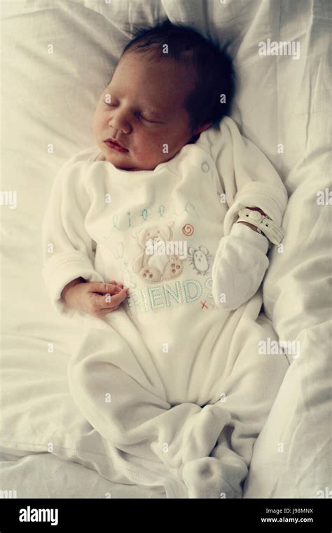 Headshot of newborn baby girl sleeping soundly with black hair Stock ...