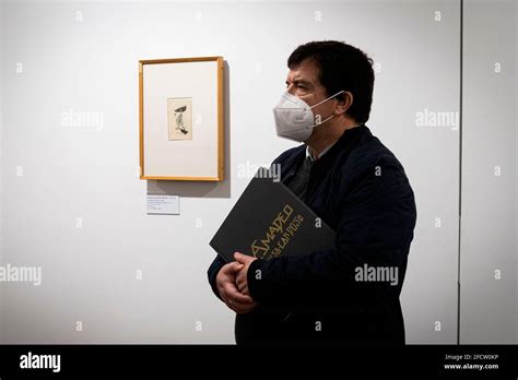 A Man Is Seen Holding The Catalogue Of The Exhibition The Exhibition