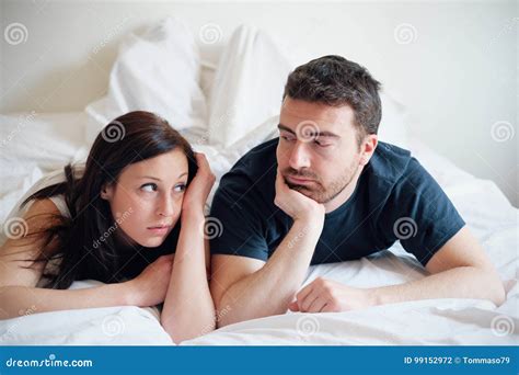 Worried And Bored Lovers Couple After A Fight Lying In Bed Royalty Free