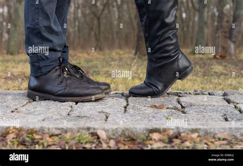 Suggestive Image Of A Girl Reaching Up For A Kiss Showing The Feet Of