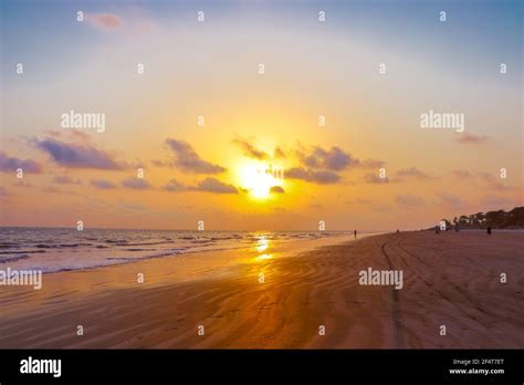 sunset landscape photo of Kuakata sea beach . evening sky reflected on wet sand Stock Photo - Alamy