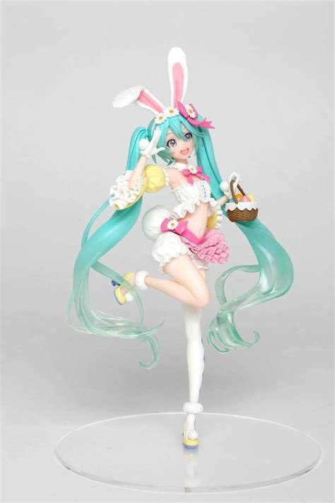 an anime figurine is posed on a white base with blue hair and bunny ears