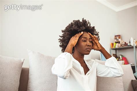 Woman Suffering From Stress Or A Headache Grimacing In Pain