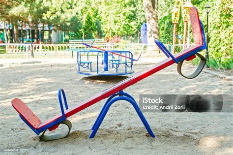 Empty Seesaw On Playground In Public Park Wooden Seesaw In The Park