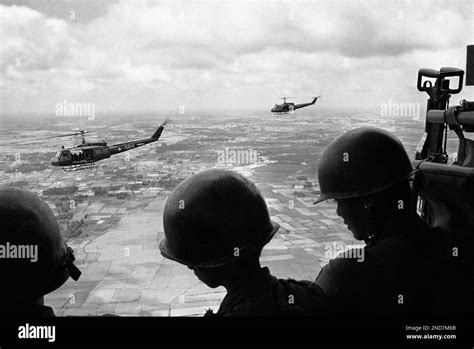Helmeted South Vietnamese Soldiers Gaze From Helicopter Over Flooded