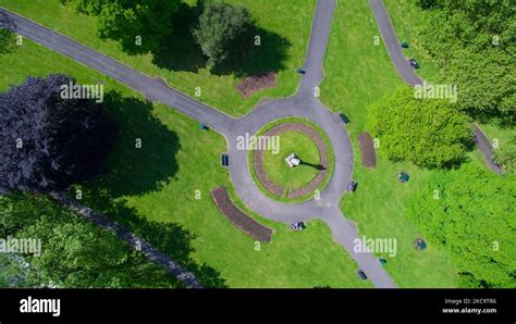 An Aerial Top View Of A Green Park With Pathways Near Green Trees On A