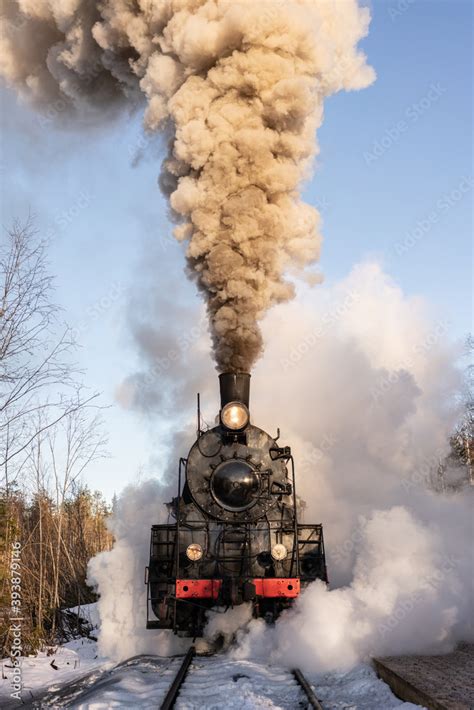 Old vintage steam train on the rail road. Steam, smoke covering the ...