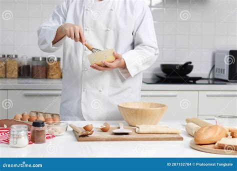 Happy Smiling Asian Man In White Chef Uniform With Hat Stirring And