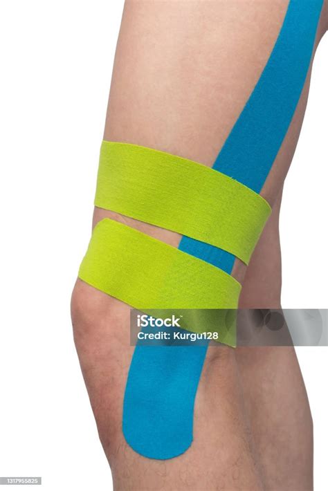 On A White Background The Knee Is Glued With Kinesio Tapes To Relieve