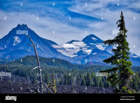 Three Sisters Mountain Range beyond the ancient lava flow in Central ...