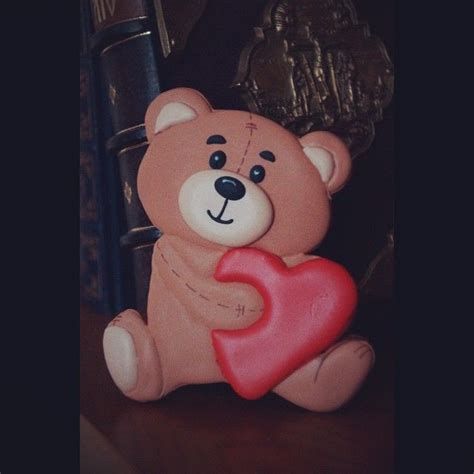 A Brown Teddy Bear Holding A Red Heart