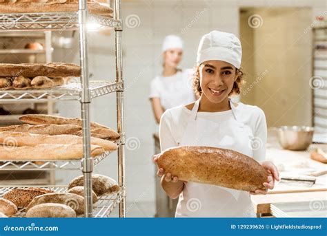 Female African American Baker With Fresh Loaf Of Bread Stock Photo