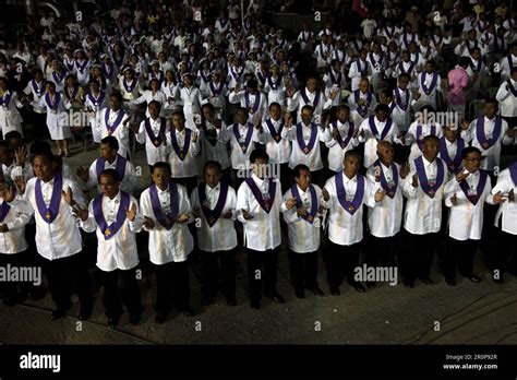 Members of El Shaddai clad in white, participating in the mass celebrated like every Saturday at ...