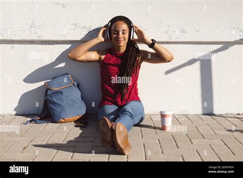 Happy African American Woman Smiling With Eyes Closed Sitting On