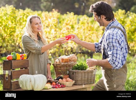Blonde Customer Discussing With The Farmer Stock Photo Alamy