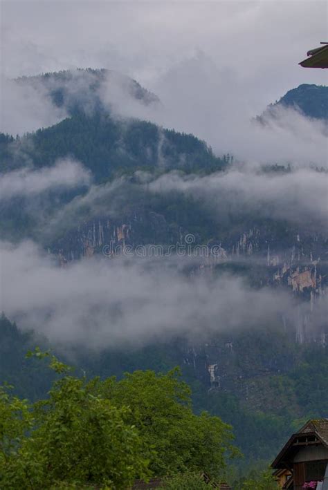 Wooded Mountain Slopes And Mountain Ranges Shrouded In Layers Of Clouds