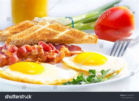 Bacon With Sunny Side Up Eggs Served With Toasts Stock Photo