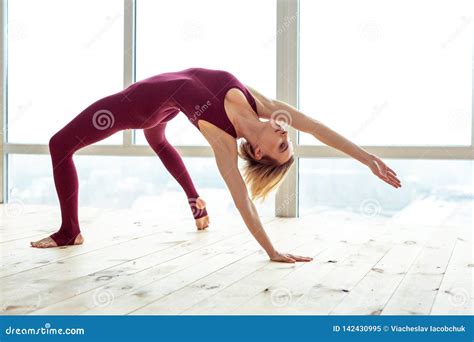 Peaceful Good Looking Woman Using Her Body Flexibility For Extreme