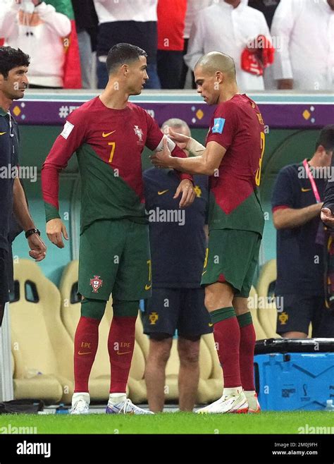 Portugal's Pepe gives the captain's armband to Portugal's Cristiano Ronaldo as he leaves the ...