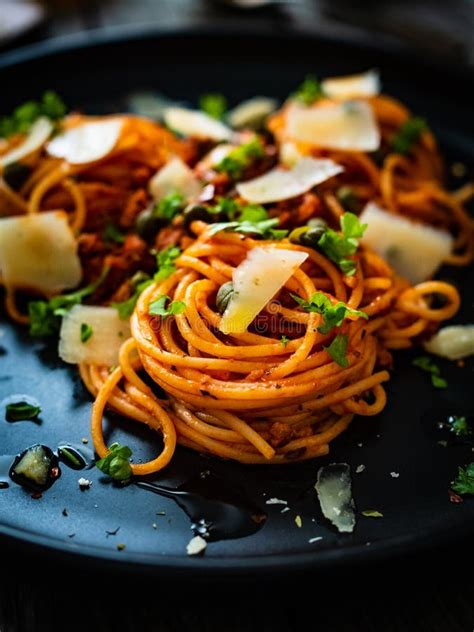 Spaghetti A La Bolognese With Minced Pork Meat And Parmesan On Wooden